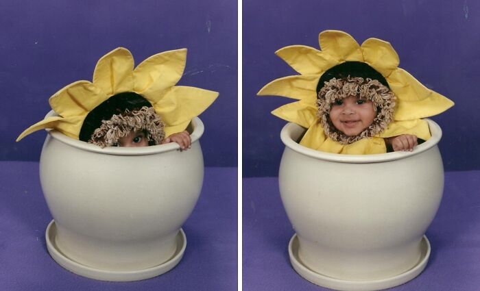 Toddler dressed in a sunflower Halloween costume sitting inside a large white flower pot, creative kids costume idea.