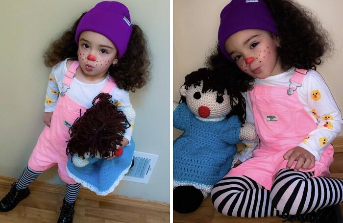 Toddler girl in pink overalls and striped tights holding a doll, showcasing creative kids Halloween costume ideas.