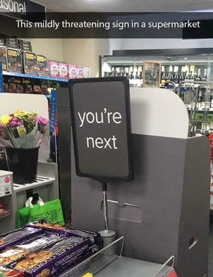 Mildly threatening sign in a supermarket checkout area, perfect for hilarious posts and instant memes.
