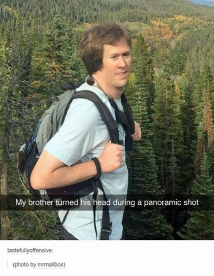 Man with backpack posing awkwardly in forest, hilarious photo that accidentally became an instant meme from a panoramic shot.