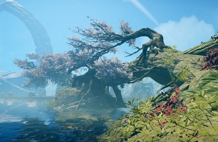 Magical imaginary world with ancient twisted tree and calm water under a bright blue sky in a mysterious landscape.