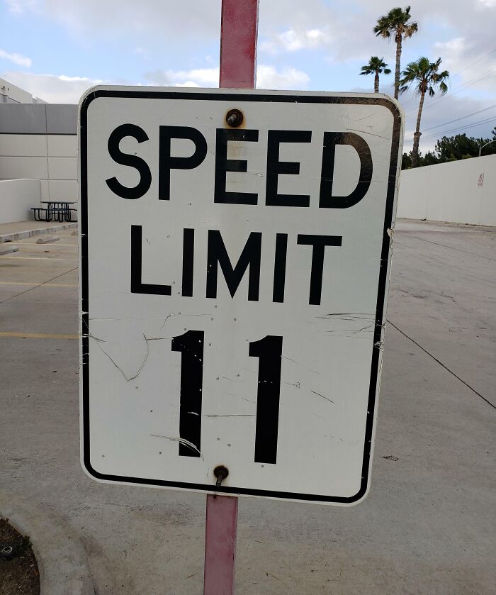 Speed limit 11 road sign in a parking lot illustrating confusing road signs that make people ignore GPS directions.