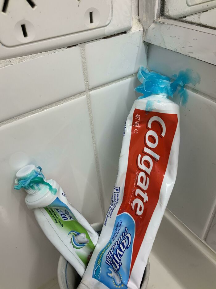 Two toothpaste tubes with messy blue toothpaste squeezed out, showing mildly infuriating moments that tested patience.