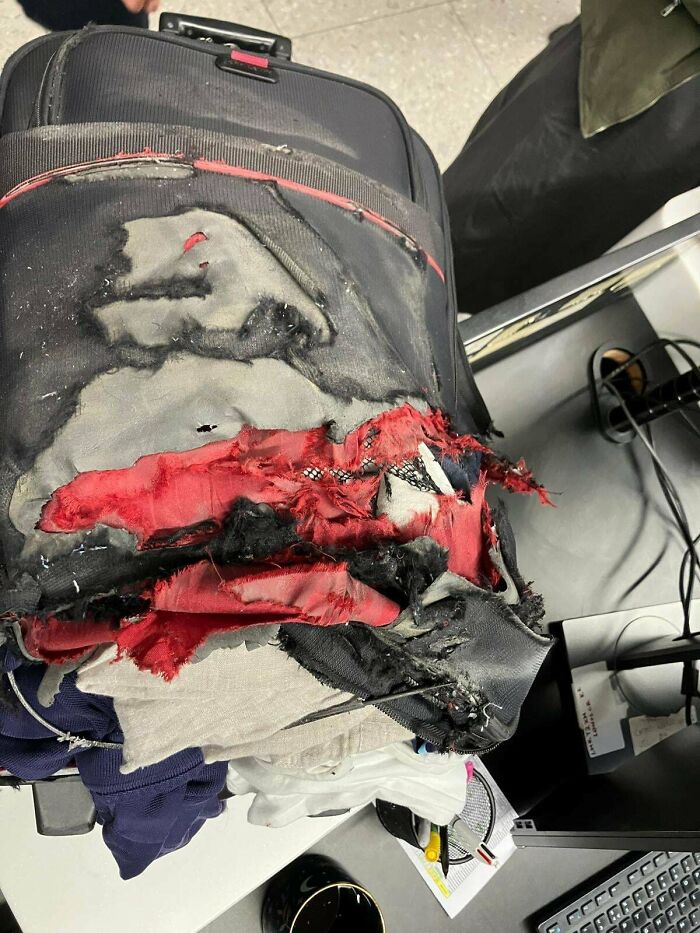 Worn-out suitcase with torn fabric and visible damage, illustrating mildly infuriating things that tested patience.