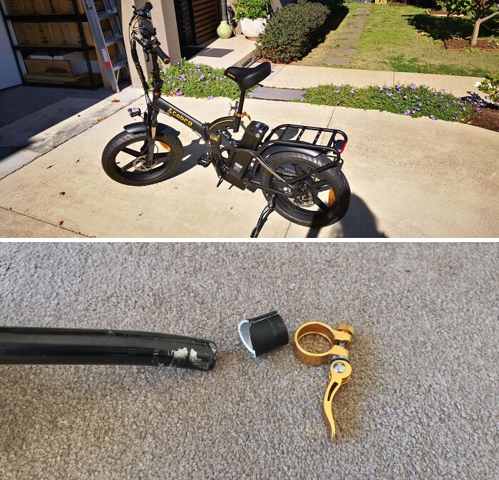 Electric bike parked outside with a broken handlebar clamp and a snapped metal tube on carpeted floor.