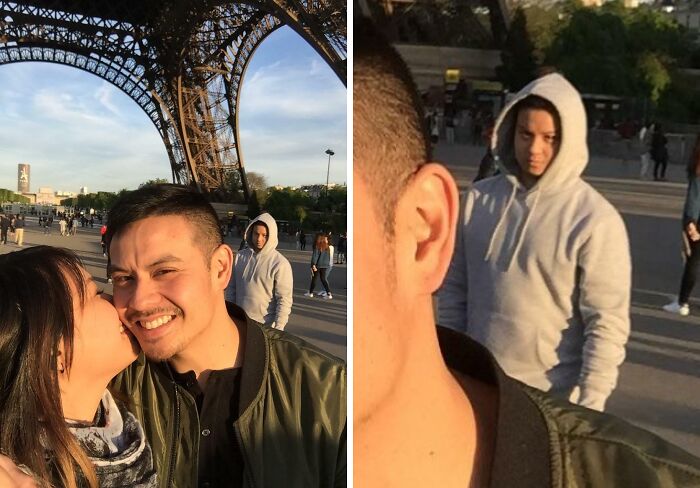 Couple kissing near Eiffel Tower with a photobomb in a gray hoodie creating a perfect photobomb moment.