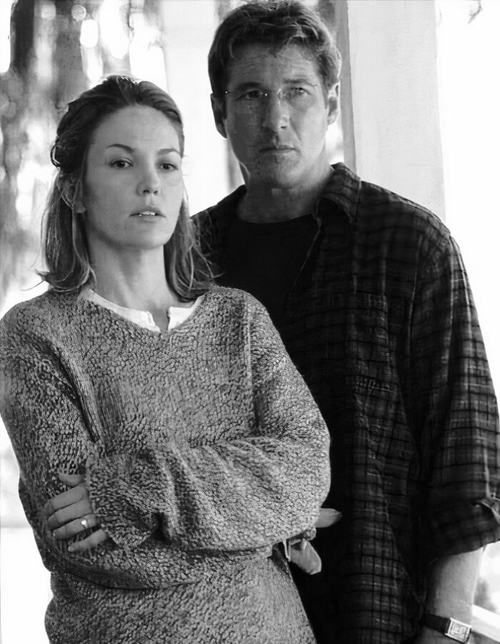 Black and white photo of two actors standing side by side, capturing a moment in the movie and music industries.