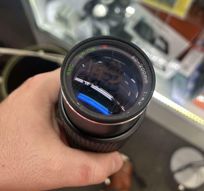 Close-up of a camera lens with a dusty front glass, illustrating one of the mildly infuriating things that test patience.