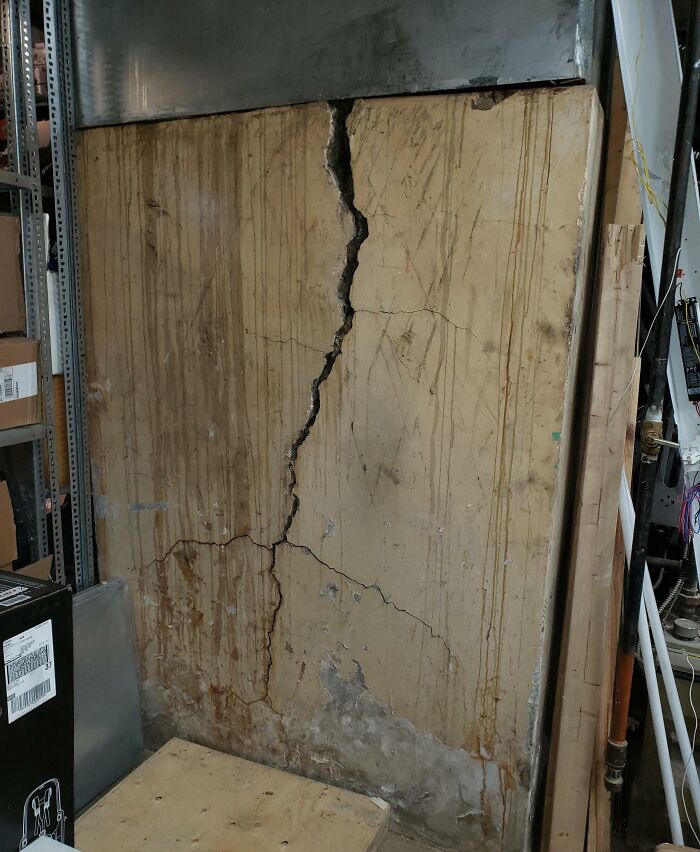 C*****d and stained wall in an industrial setting, illustrating unsettling conditions related to jobs that should pay more.