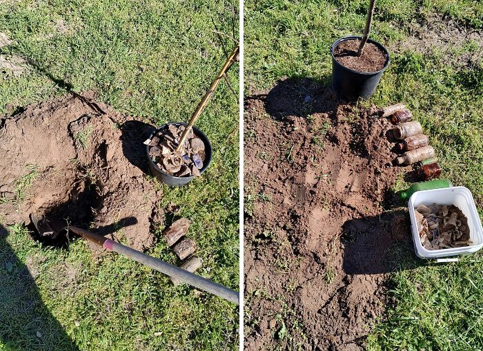 A shallow hole dug in grass with broken glass and rusty bottles, illustrating mildly infuriating things testing patience.