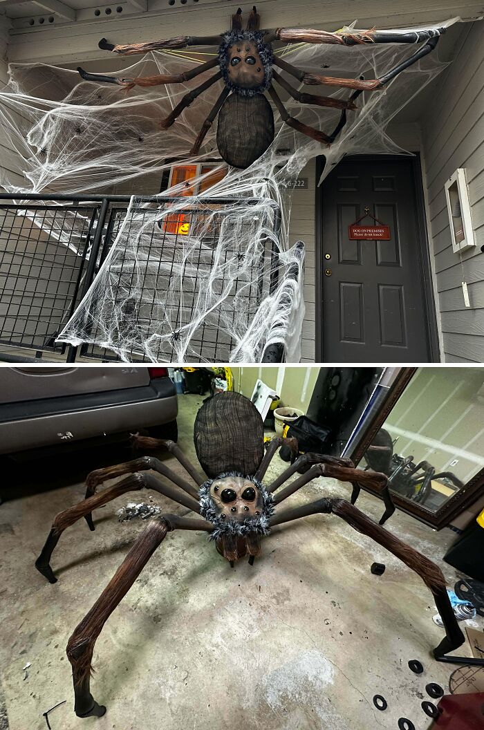 Large realistic spider Halloween decoration with webbing on outdoor porch, showcasing impressive outdoor Halloween decorations.