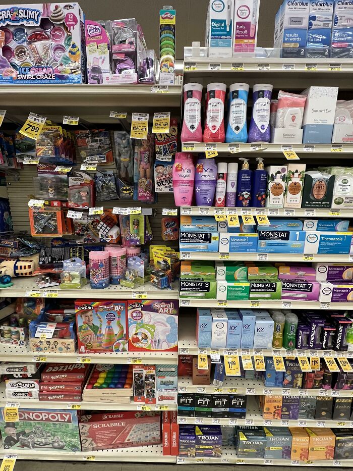 Grocery store shelves stocked with toys, health, and personal care items creating a seemingly accidental comedy scene.