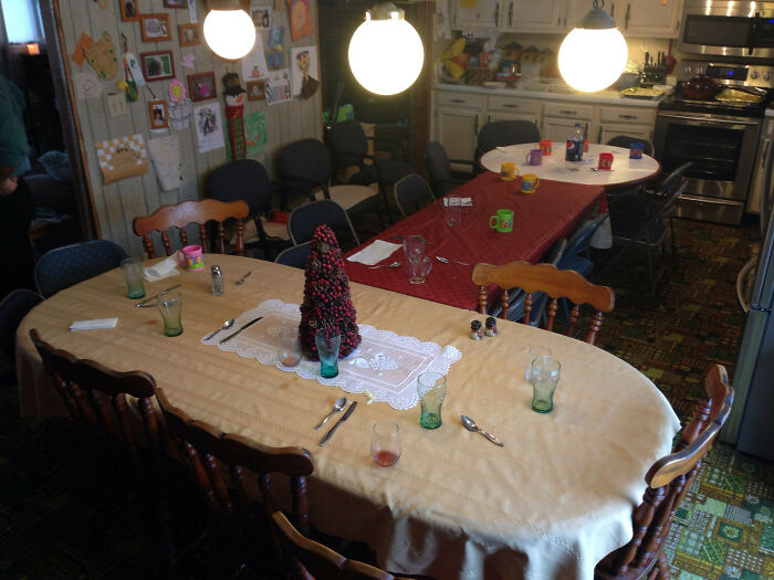 Dining room with empty glasses and mugs on tables, creating an accidental comedy scene with harmless everyday items.