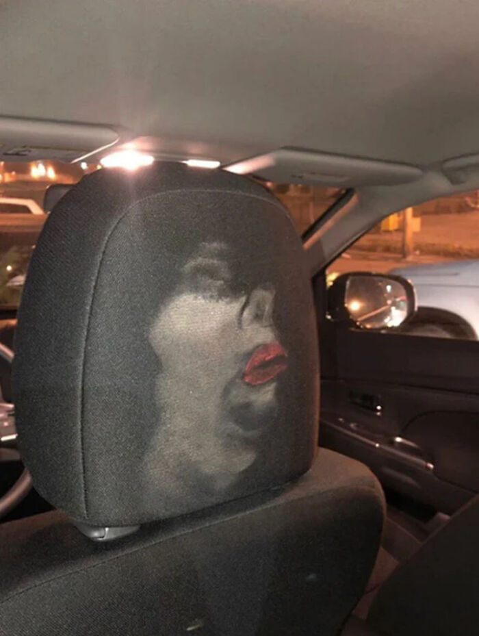 Car seat with accidental comedy effect showing a funny face formed by dust and stains on the fabric.