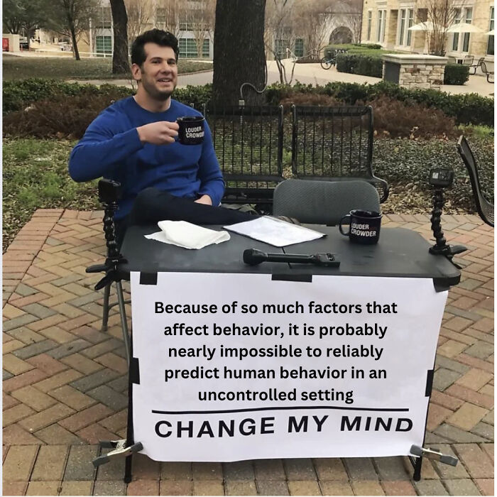 Man sitting at a table with psychology meme about human behavior predicting challenges in an outdoor setting.