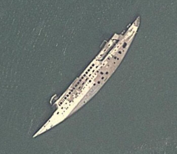 Aerial view of a sunken shipwreck captured on Google Earth revealing an unexpected maritime scene.