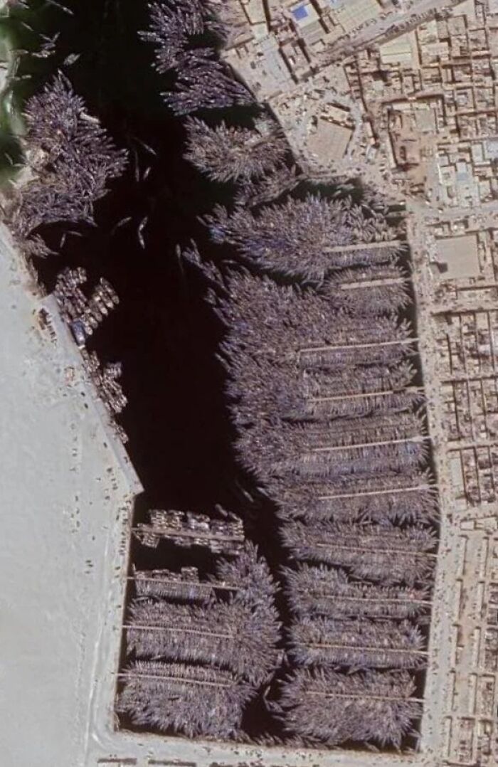 Aerial view captured on Google Maps showing an unexpected dense cluster of boats tightly packed in a harbor.