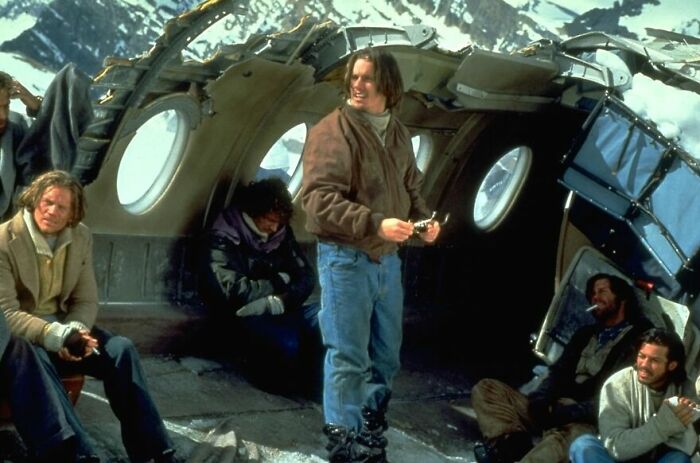 Survivors inside a crashed plane in snowy mountains, a dramatic scene from movies based on true stories.