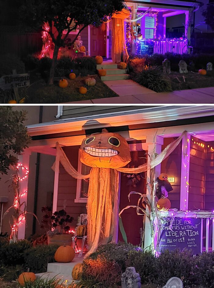 Outdoor Halloween decorations featuring pumpkins, skeletons, and colorful lights on a front porch display at night.