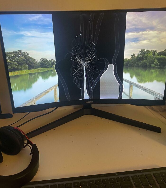 Curved monitor with a c*****d screen displaying a serene lake view, illustrating mildly infuriating things testing patience.