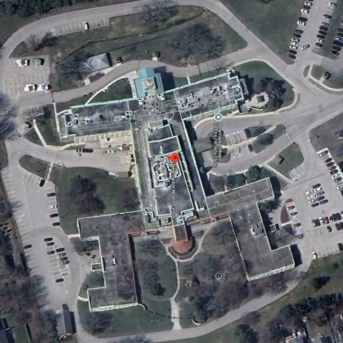 Aerial view of a large health center captured on Google Earth revealing unexpected map details and surrounding parking areas.