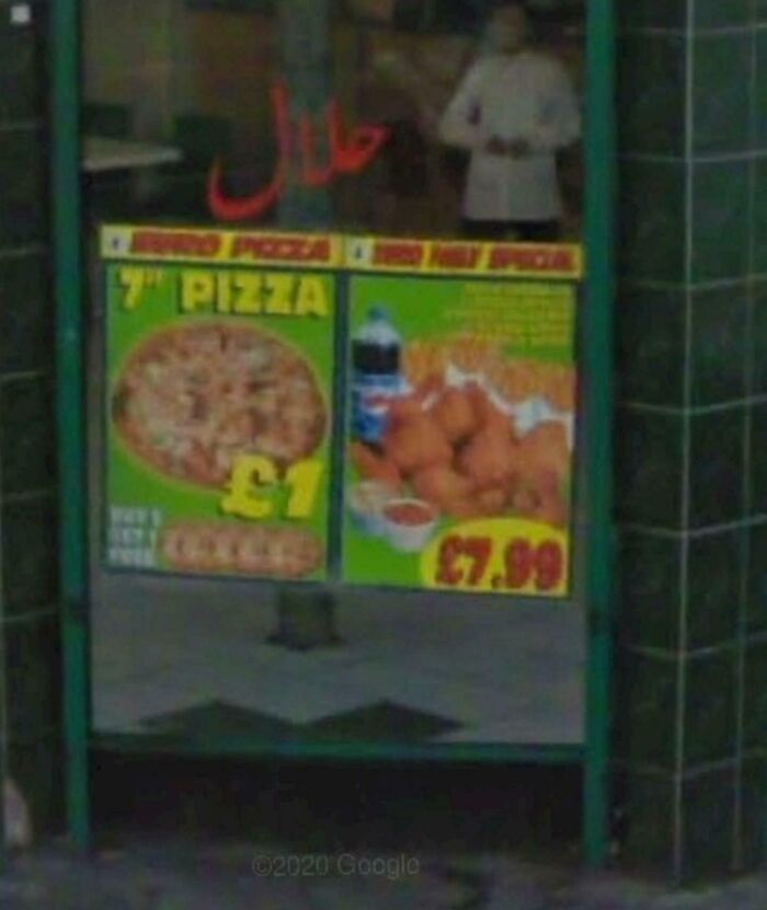 Street view showing pizza and food prices on a window, an unexpected capture from Google Earth and Maps.