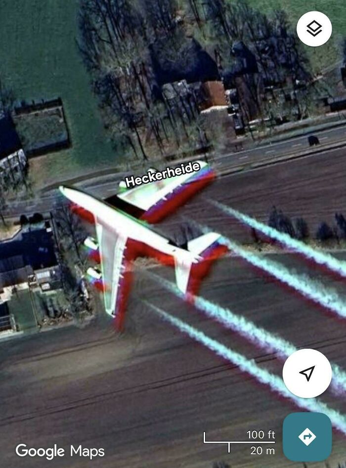 Satellite view of an airplane captured in motion with vapor trails, showcasing unexpected moments on Google Earth and Maps.