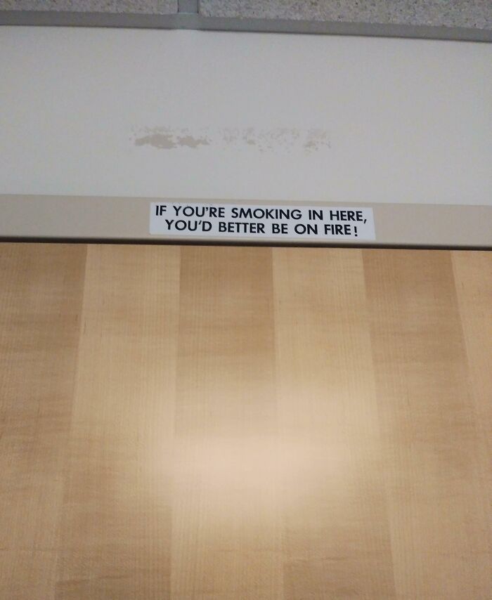 Sign on a door humorously warning smokers to be on fire, showcasing hilarious and wholesome doctor actions to ease patients.