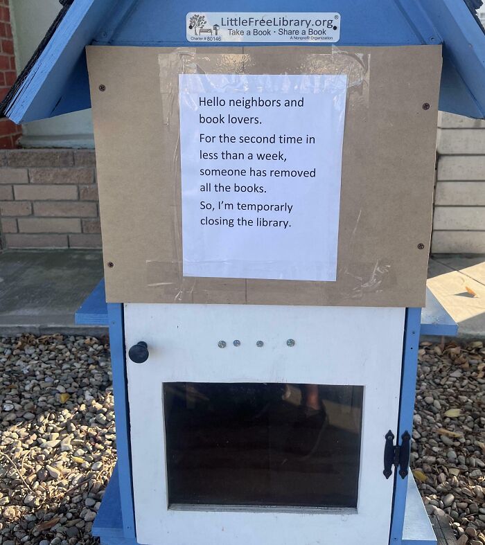 Little Free Library box with a note about temporary closure after books were repeatedly removed, testing people’s patience.
