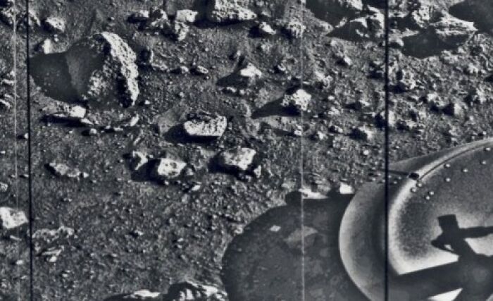 Black and white vintage photo showing rocky terrain and partial machinery from early photography era.