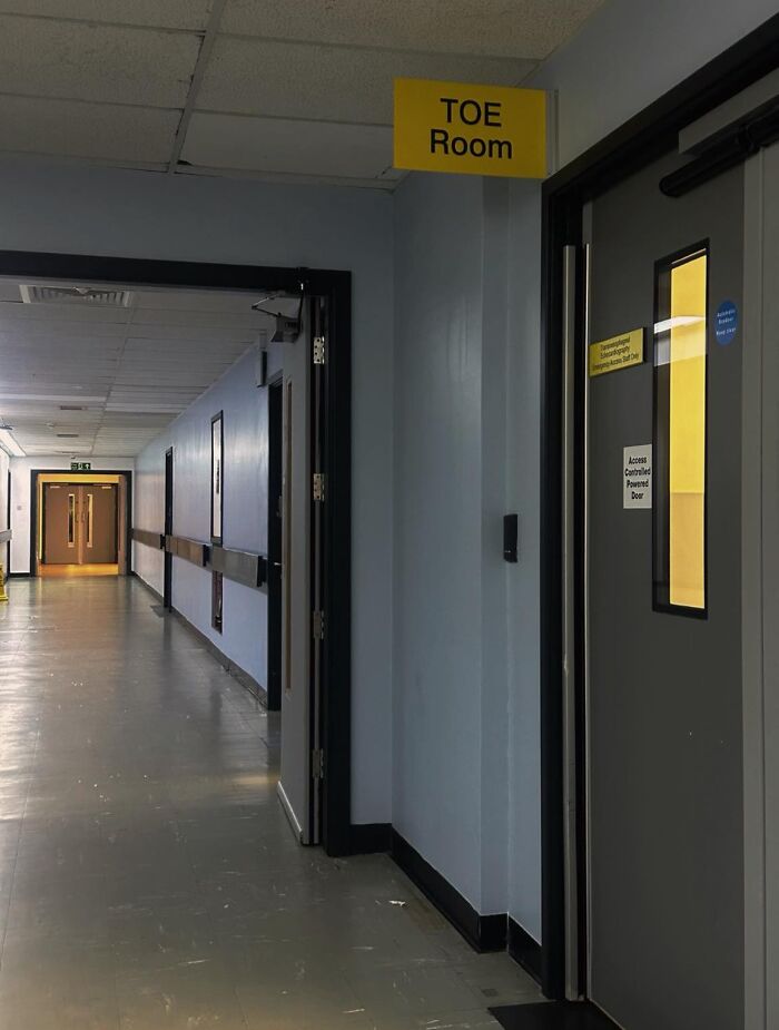 Empty hospital hallway featuring a door labeled TOE Room, illustrating beautiful yet unnerving liminal spaces.