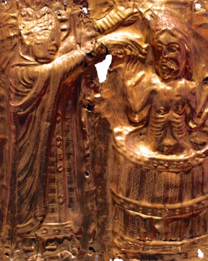 Ancient Viking artifact showing detailed gold engraving of two figures, highlighting interesting and little-known Viking facts.