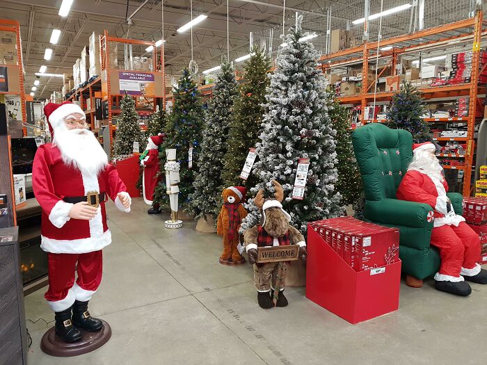 Store display of Christmas trees and Santa figures, illustrating Halloween fails with early holiday decorations indoors.
