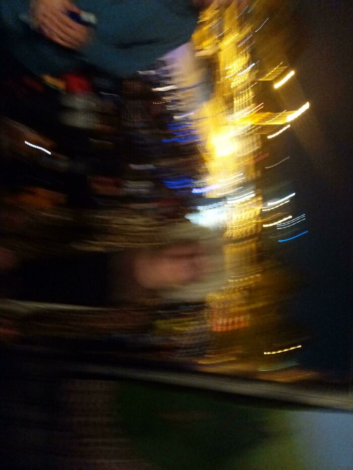 Blurry nighttime photo with distorted figures and streaks of light, capturing Halloween fails and spooky atmosphere.