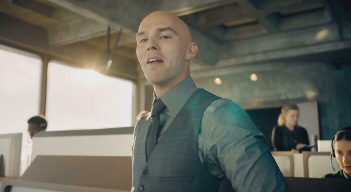 Man in a vest and tie in an office setting, representing a bad movie detail from an online group dedicated to confusing scenes.