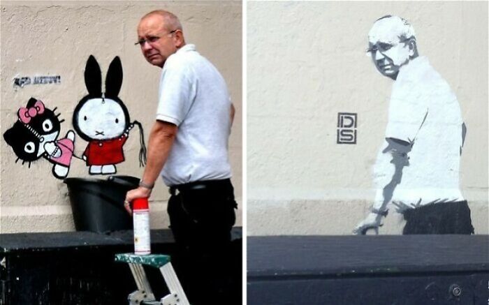 Man painting vibrant and powerful street art featuring cartoon characters and a grayscale portrait on an urban wall.