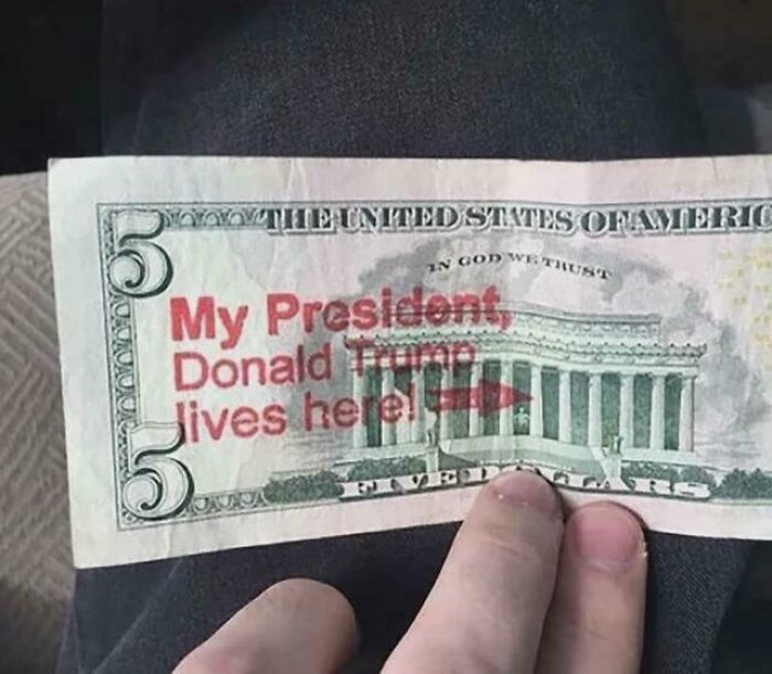 Five dollar bill with red text saying My President Donald Trump lives here, highlighting facepalm moments of absent common sense.