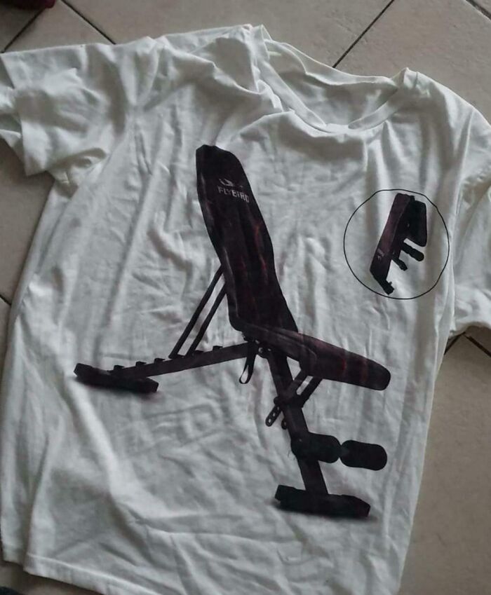 White T-shirt with a printed gym bench design showing a careless online shopping fail of a workout bench image.