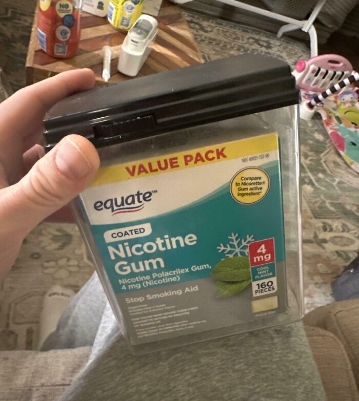 Large value pack of coated nicotine gum held in hand, showcasing a humorous example of careless online shopping backfiring.