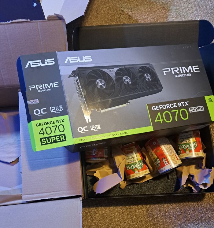 ASUS GeForce RTX 4070 Super graphics card box opened to reveal canned food inside, showcasing careless online shopping fail.