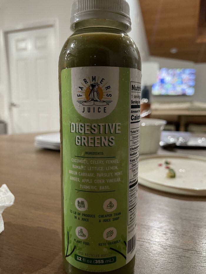 Green digestive juice bottle on a table with nutritional information, related to Halloween fails concept.
