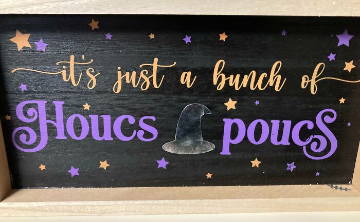Wooden Halloween sign with the phrase Houcs pocus and witch hat, featuring stars in purple and orange Halloween fails decor.