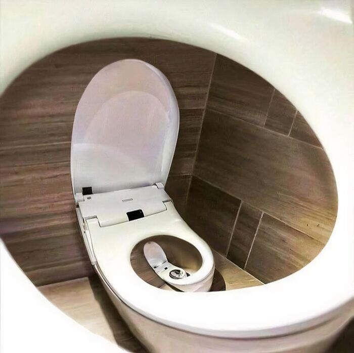 Confusing image of a toilet with a spiral effect creating an endless loop, making things only get weirder the longer you look.