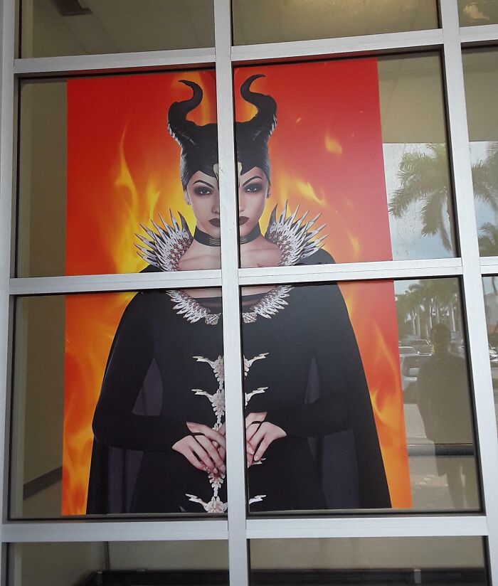 Halloween fail with a distorted costume poster split by window panes creating a double-headed character effect.