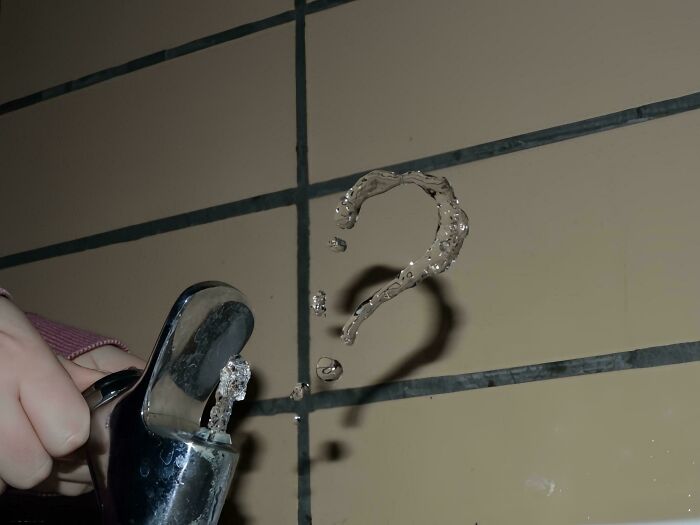 Water droplets shaped like a question mark near a faucet, part of a collection of pictures that go hard and make people chuckle.