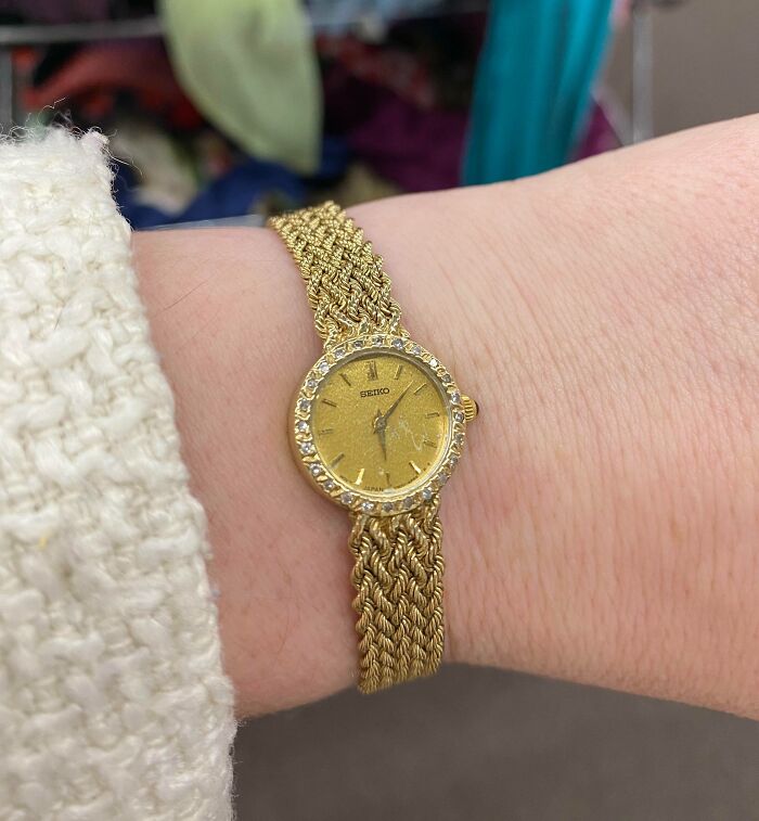 Gold Seiko watch with a jeweled bezel on wrist, a lucky thrift store find by a happy shopper.