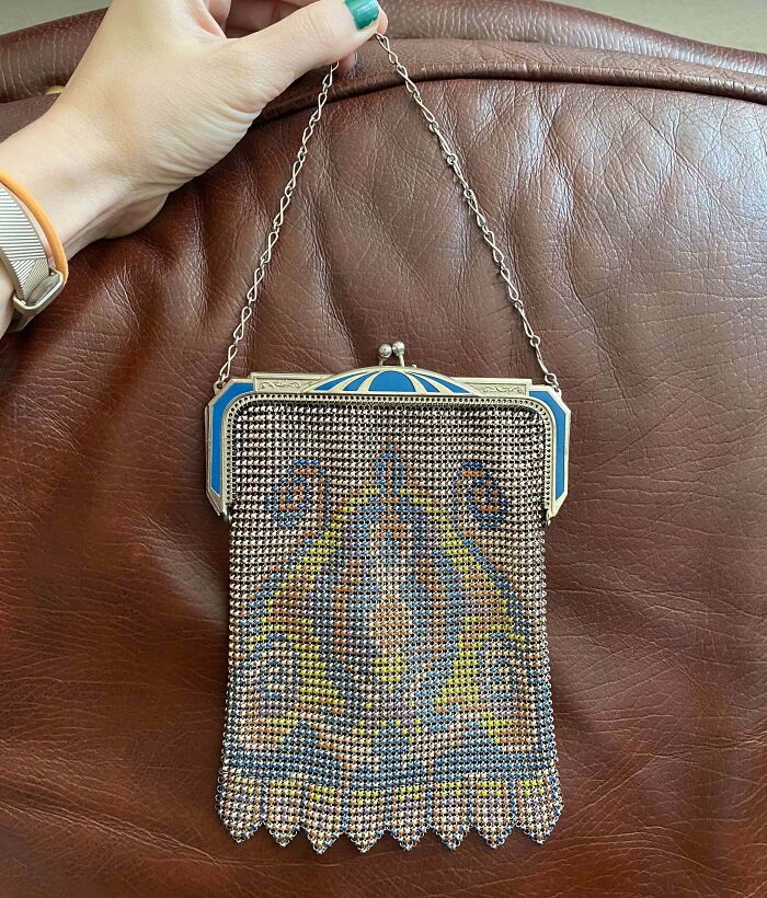 Vintage beaded purse with intricate design held by hand, a lucky thrift store shopper's jackpot find.
