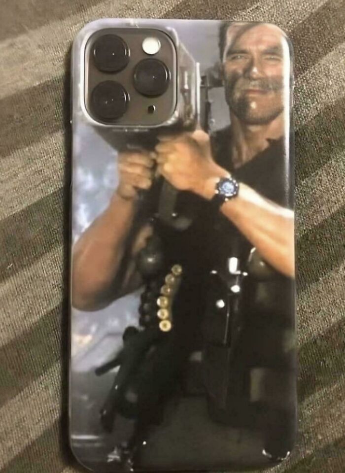 Phone case with a humorous image of a muscular man holding a large gun, popular in funny pictures that go hard.