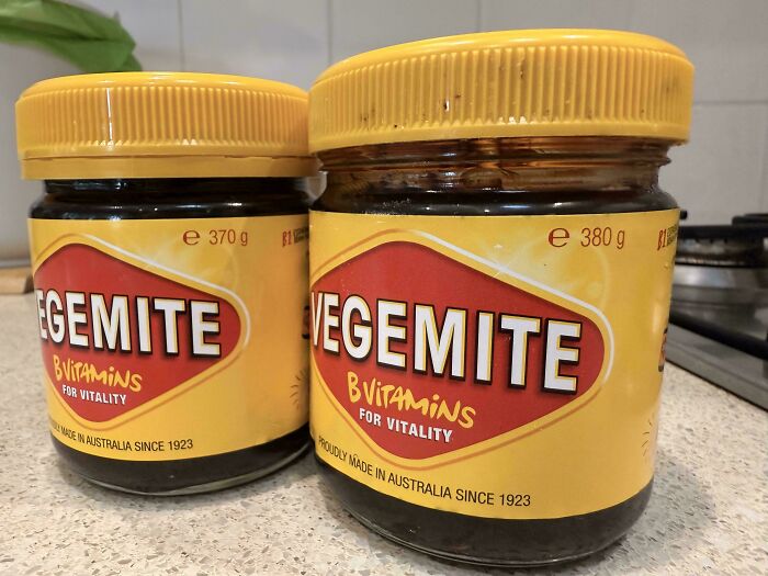 Two jars of Vegemite with yellow lids on a kitchen counter, illustrating examples of sneakflation in grocery products.