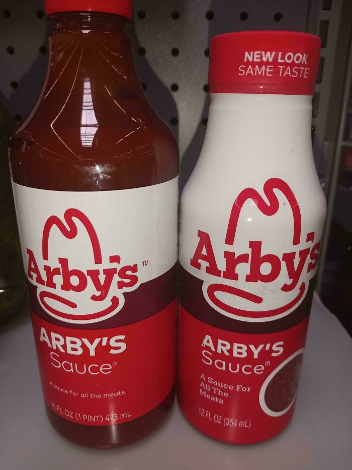 Two bottles of Arby's sauce in different sizes on a store shelf illustrating examples of sneakflation in packaging.